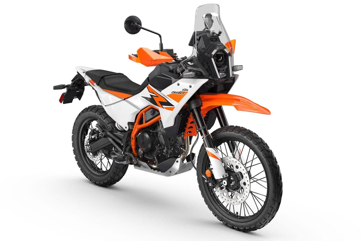 KTM 390 Adventure R in white and orange, front three-quarter studio view highlighting the beak fender, LED headlight and long-travel forks