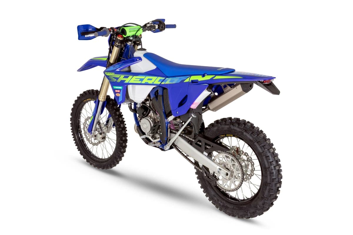 Sherco 125 SE Factory rear three-quarter studio view highlighting the white tank shrouds, chain guard and shock linkage