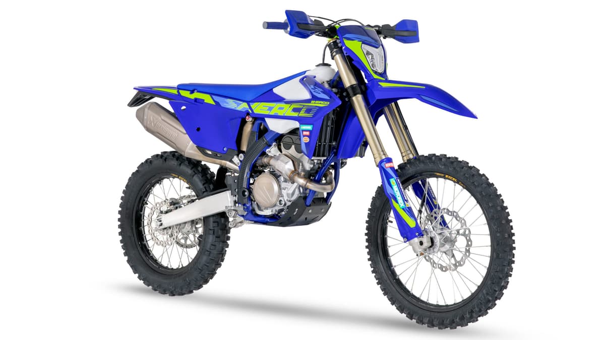 Sherco 300 SEF Factory front three-quarter studio view highlighting the tank shroud graphics, radiator shrouds and spoked front wheel with disc brake