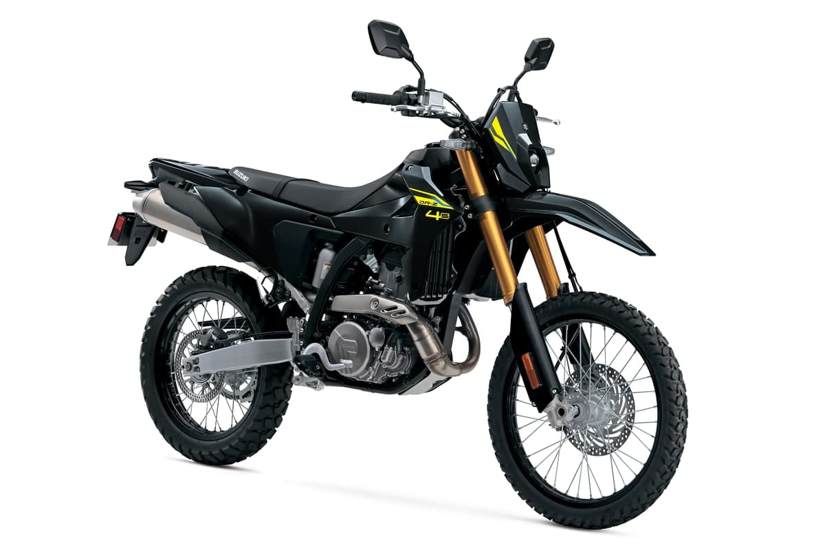 2027 Suzuki DR-Z4S in Solid Black with yellow graphics, front three-quarter studio view showing the gold-anodized KYB fork, spoked wheels and upswept stainless exhaust