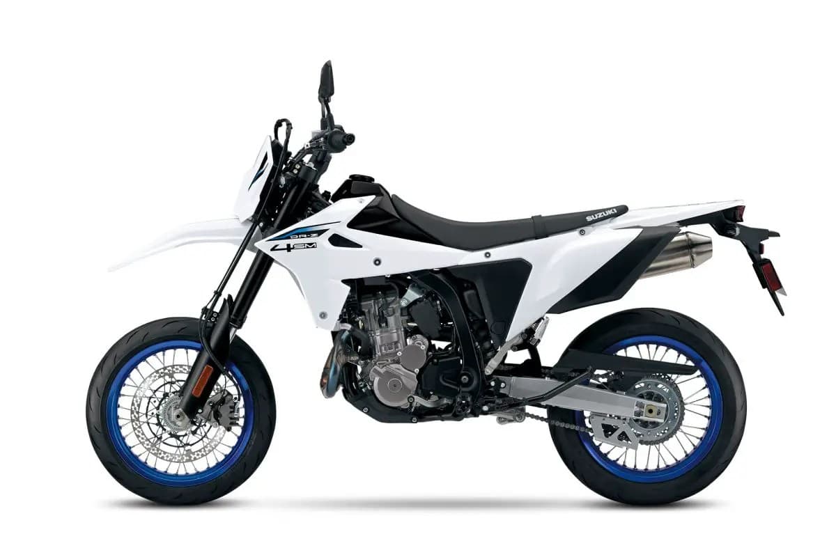 Suzuki DR-Z4SM in white with blue rims, left-side studio profile showing the blue-anodized spoked wheels, disc brakes and chain drive