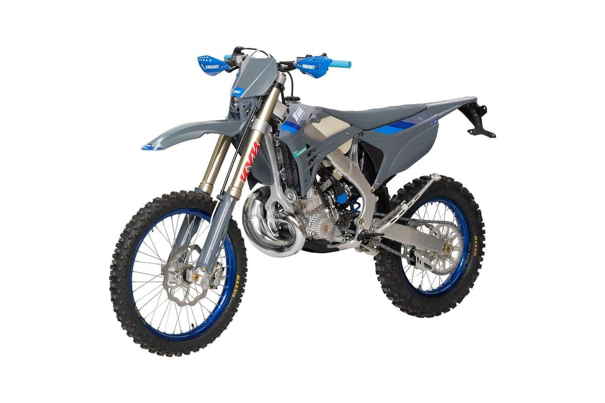 TM EN 300 FI 2T rear three-quarter studio view highlighting the chrome expansion chamber, blue-anodized wheels and knobby tires