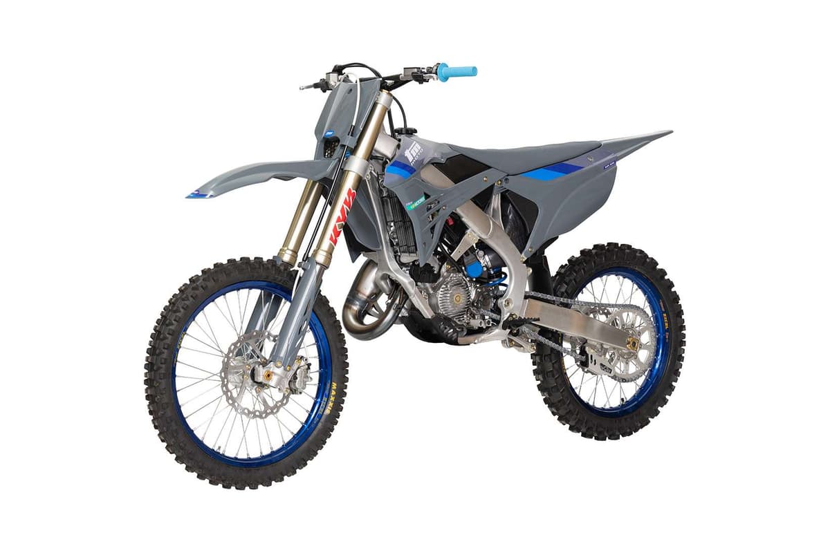 TM MX 125 2T, front three-quarter studio view highlighting the KYB fork, radiator shrouds and aluminum swingarm with blue Excel rims