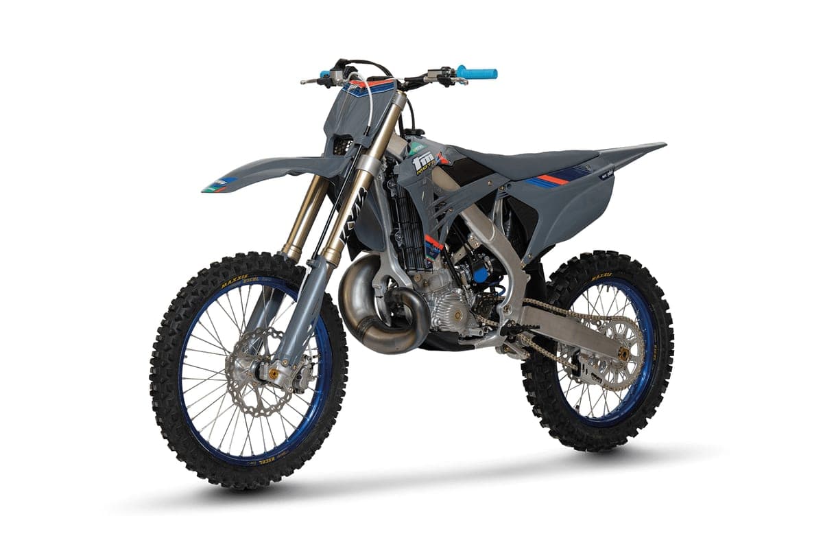 TM MX 300 FI 2T front three-quarter studio shot from the opposite angle, showing the expansion chamber, chain guard and rear disc brake