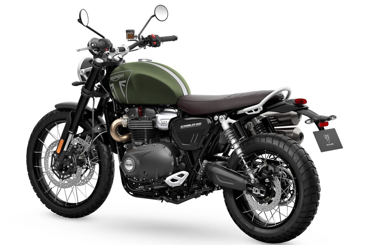 Triumph Scrambler 1200 X front three-quarter studio view highlighting the round headlight, upswept exhaust pipes and long-travel front forks