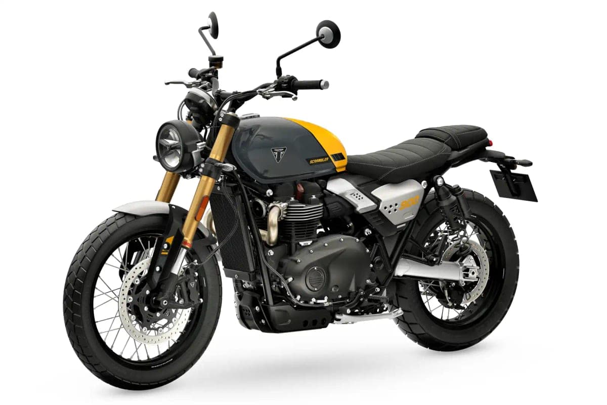 Triumph Scrambler 900 in grey and yellow, front three-quarter studio view highlighting the gold USD forks and round headlight