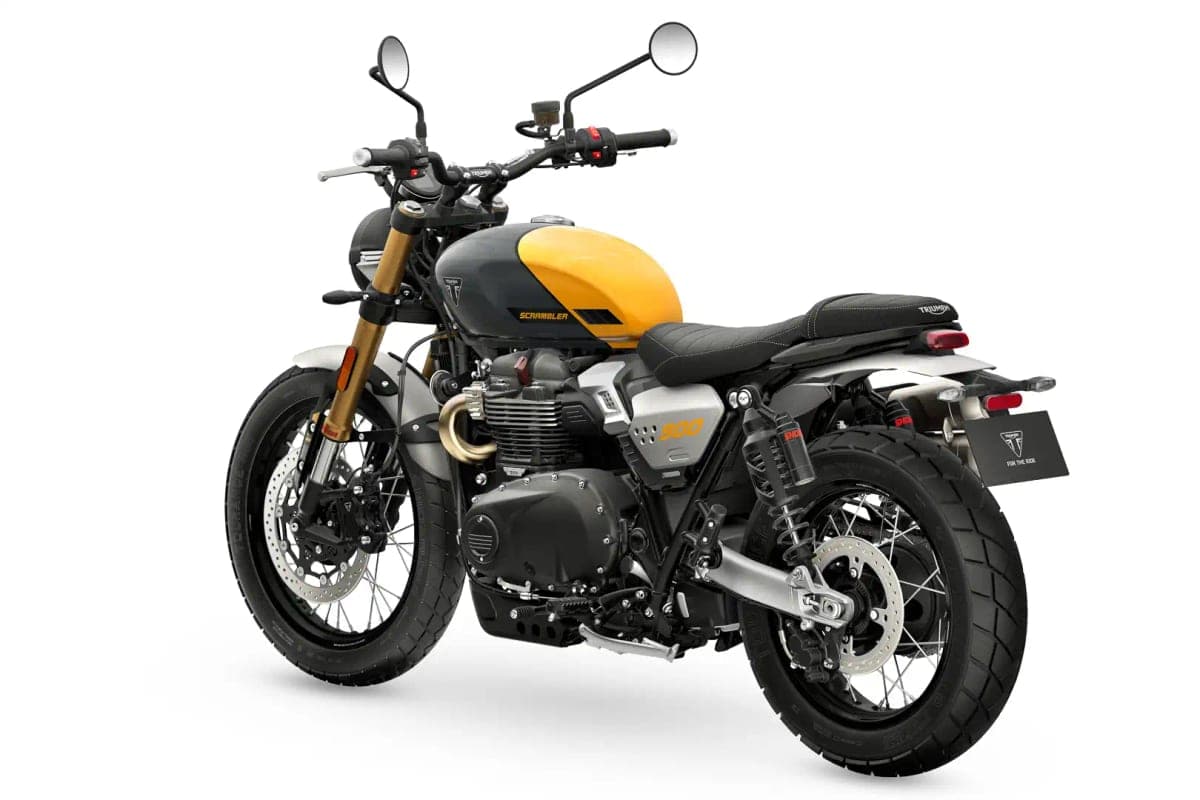 Triumph Scrambler 900 rear three-quarter studio shot from the tail, showing the piggyback rear shocks, spoked wheel and taillight