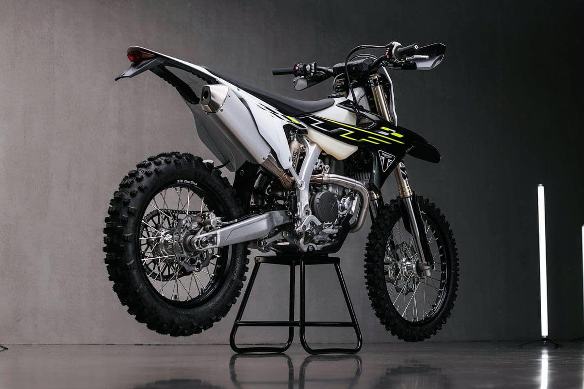 Triumph TF 450-E rear three-quarter studio shot showing the tucked exhaust, spoked wheels and black rear fender with number plate