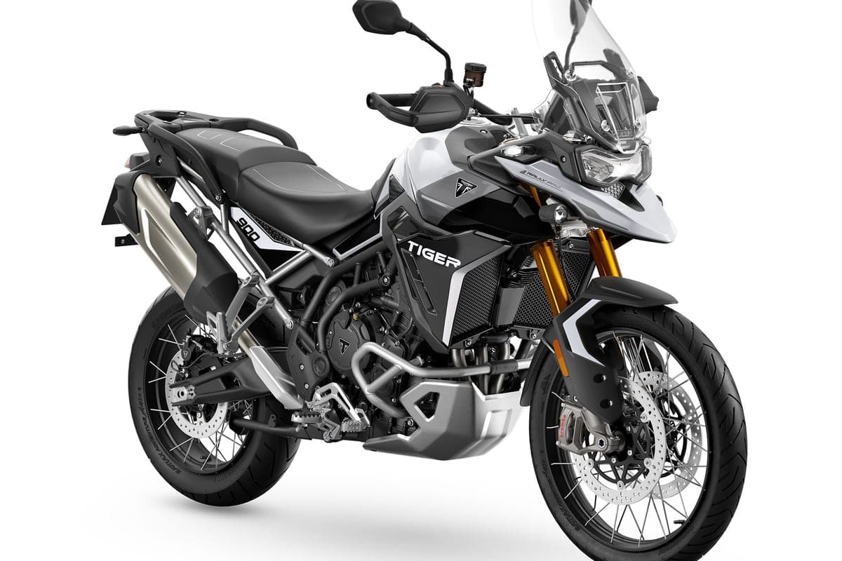 Triumph Tiger 900 Rally Pro in white and black, front three-quarter studio view highlighting the beak-style LED headlight, gold forks and Brembo front brakes