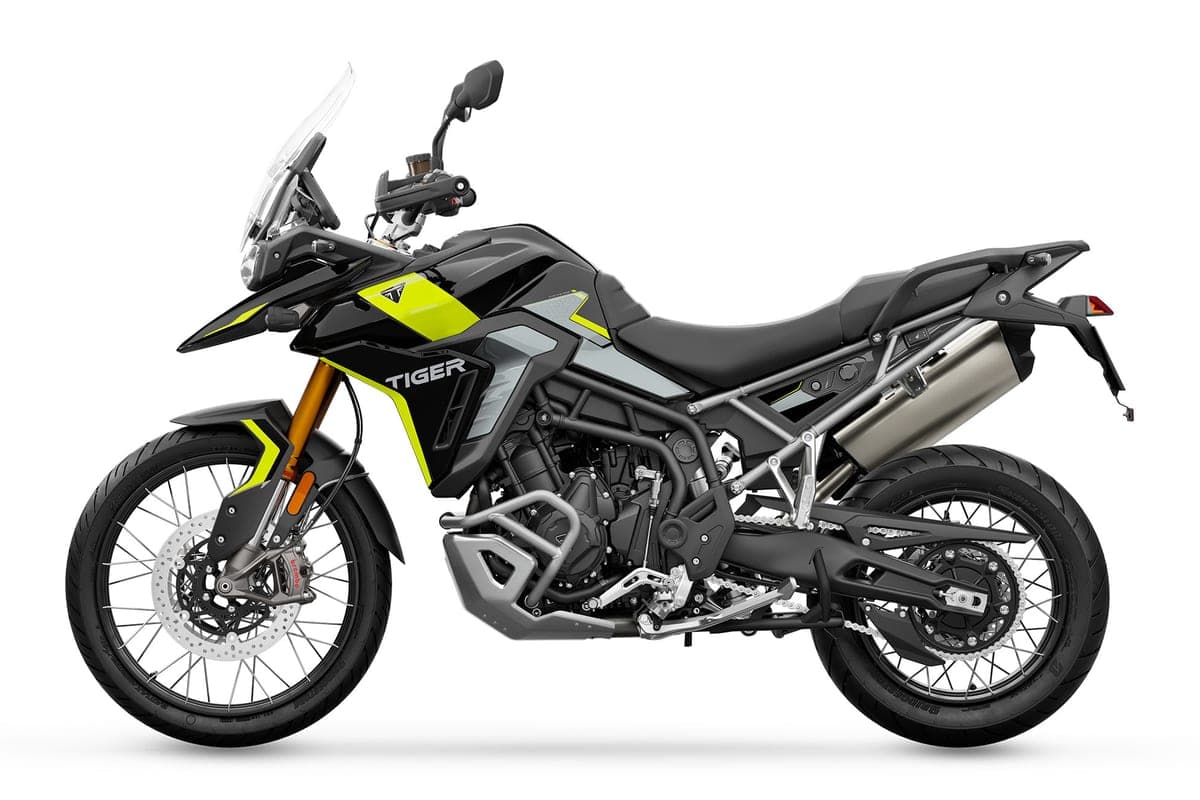 Triumph Tiger 900 Rally Pro in black with hi-vis yellow accents, left-side studio profile showing the crash bars, chain drive and upswept tail with LED taillight