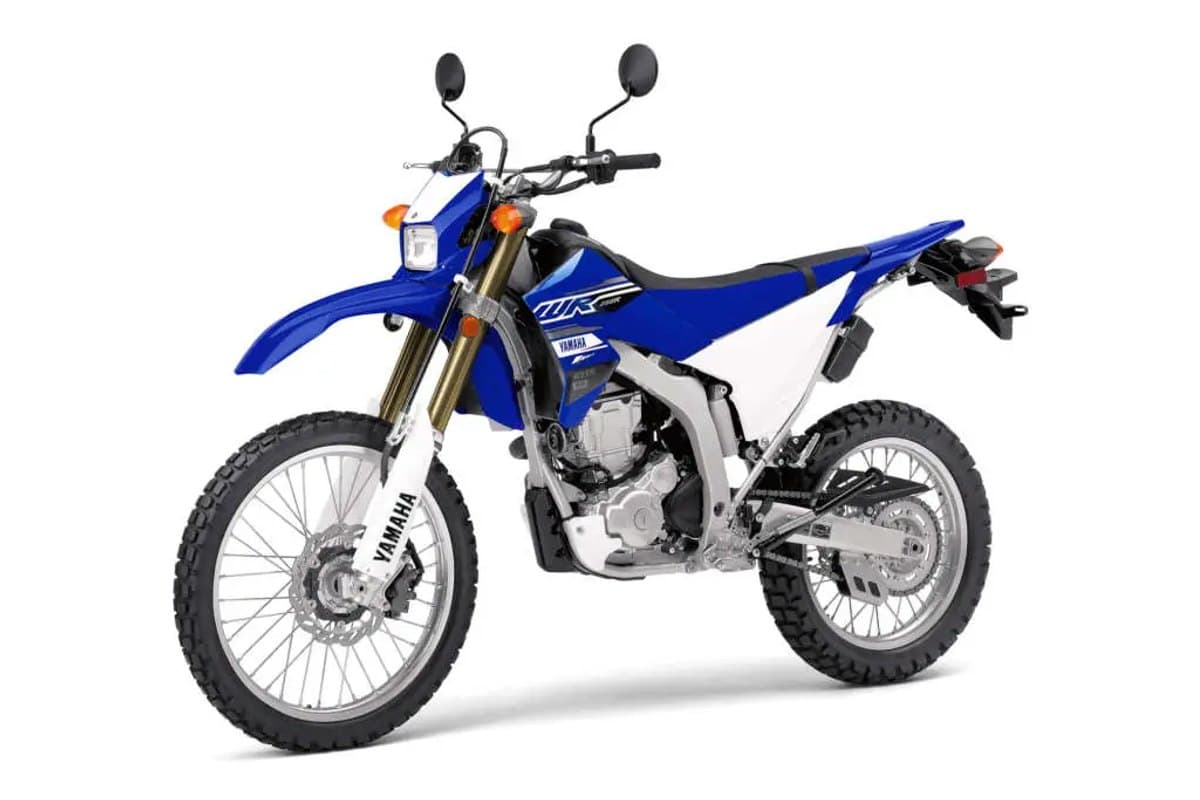 Yamaha WR250R front three-quarter studio view showing the compact headlight, hand guards and folding mirrors