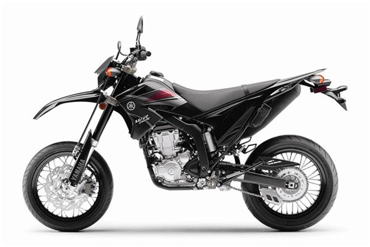 Yamaha WR250X in black, left-side studio view highlighting the inverted forks, disc brakes, upswept exhaust and chain drive