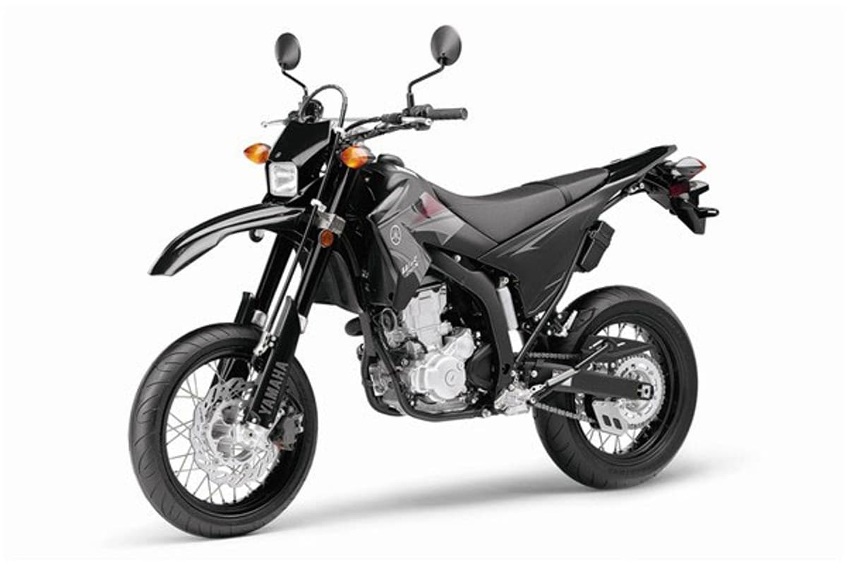 Yamaha WR250X front three-quarter studio shot showing the round headlight, dual mirrors, narrow tank and open trellis-style frame