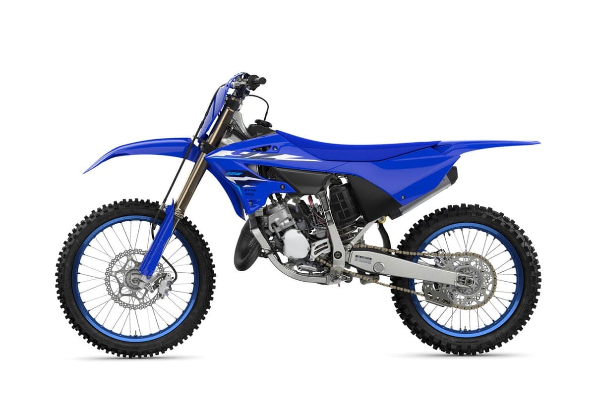 Yamaha YZ125 left-side studio profile showing the full silhouette, chain and rear disc brake, and blue-anodized wheel rims