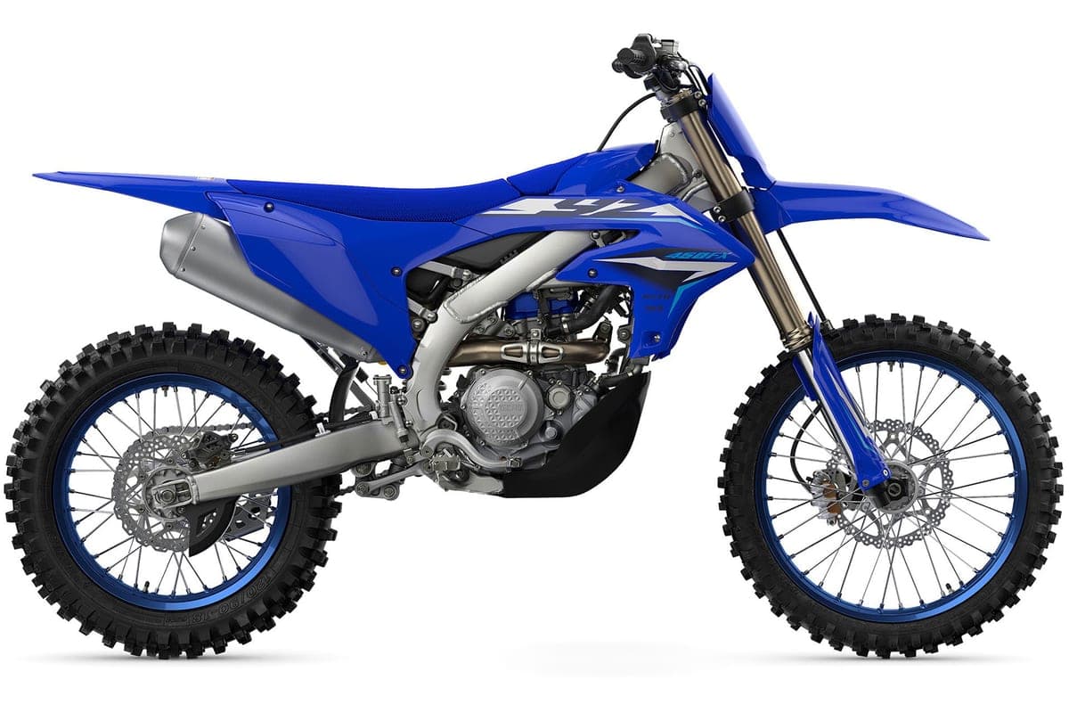 Yamaha YZ450FX right-side studio profile in blue livery, highlighting the inverted front fork, disc brakes and knobby off-road tires