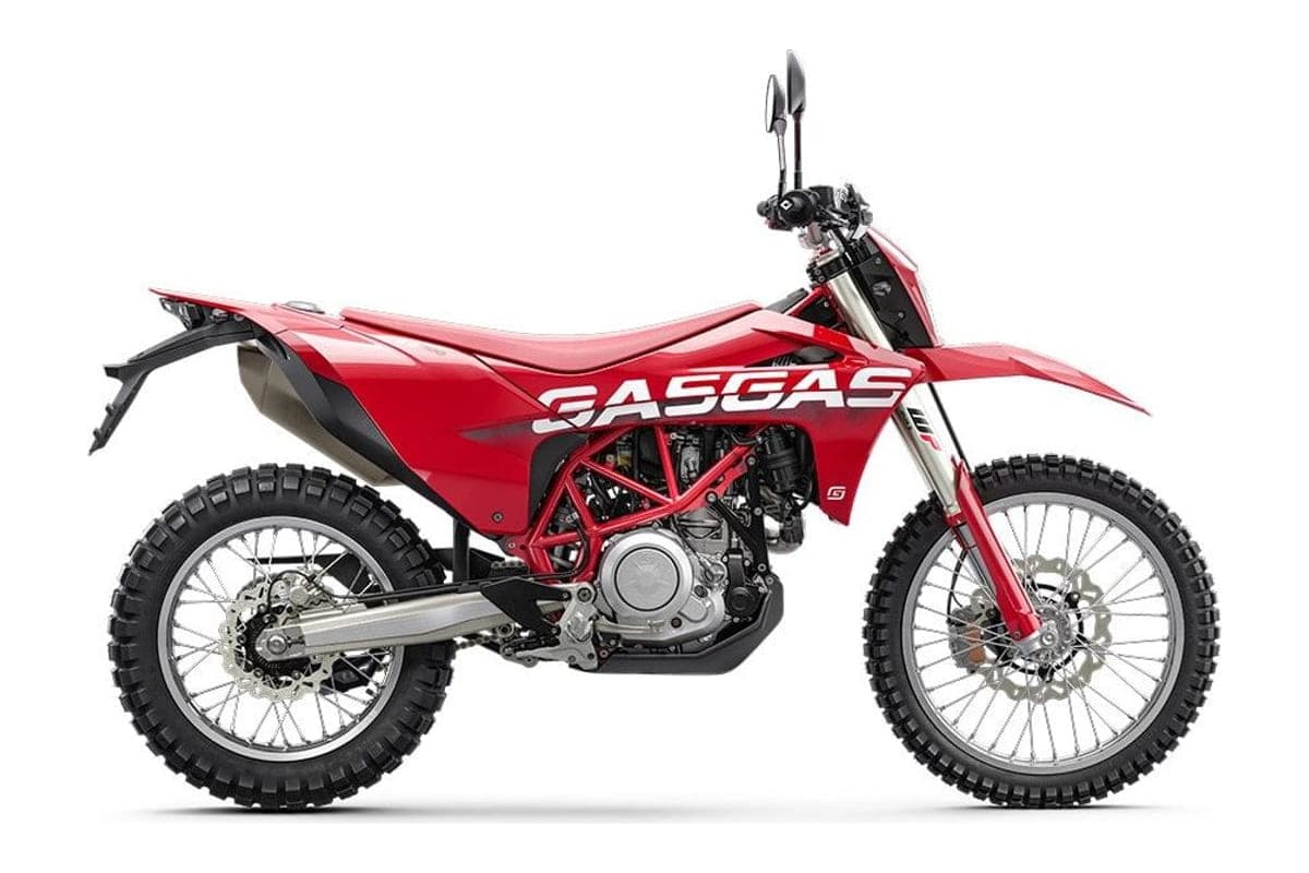 2024 GasGas ES 700 dual-sport in red and white, left-side studio profile showing the spoked wheels, skid plate and GASGAS-branded bodywork