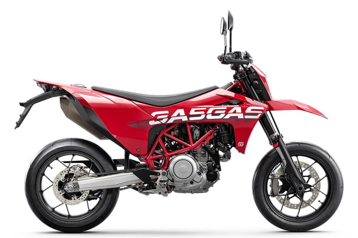 2024 GasGas SM 700 supermoto in red and white, left-side studio profile showing the red trellis frame, upswept exhaust and inverted forks