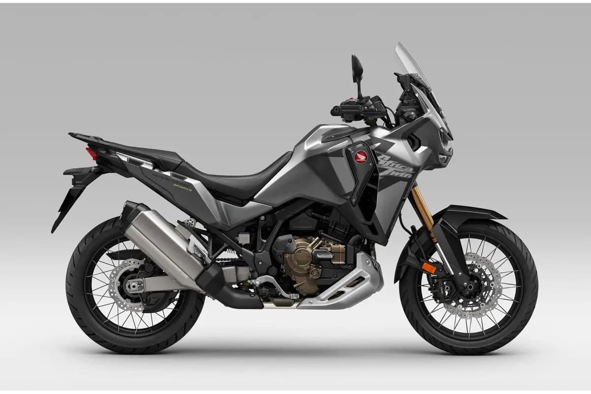 2026 Honda Africa Twin Adventure Sports ES in gunmetal grey, right-side studio profile showing gold forks, spoked wheels and tall touring windscreen