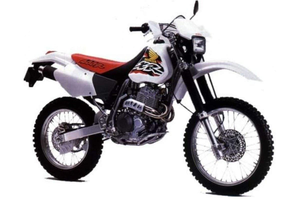 2004 Honda XR400R dual-purpose motorcycle in white and red, right-side studio profile showing spoked wheels, chrome exhaust and exposed engine