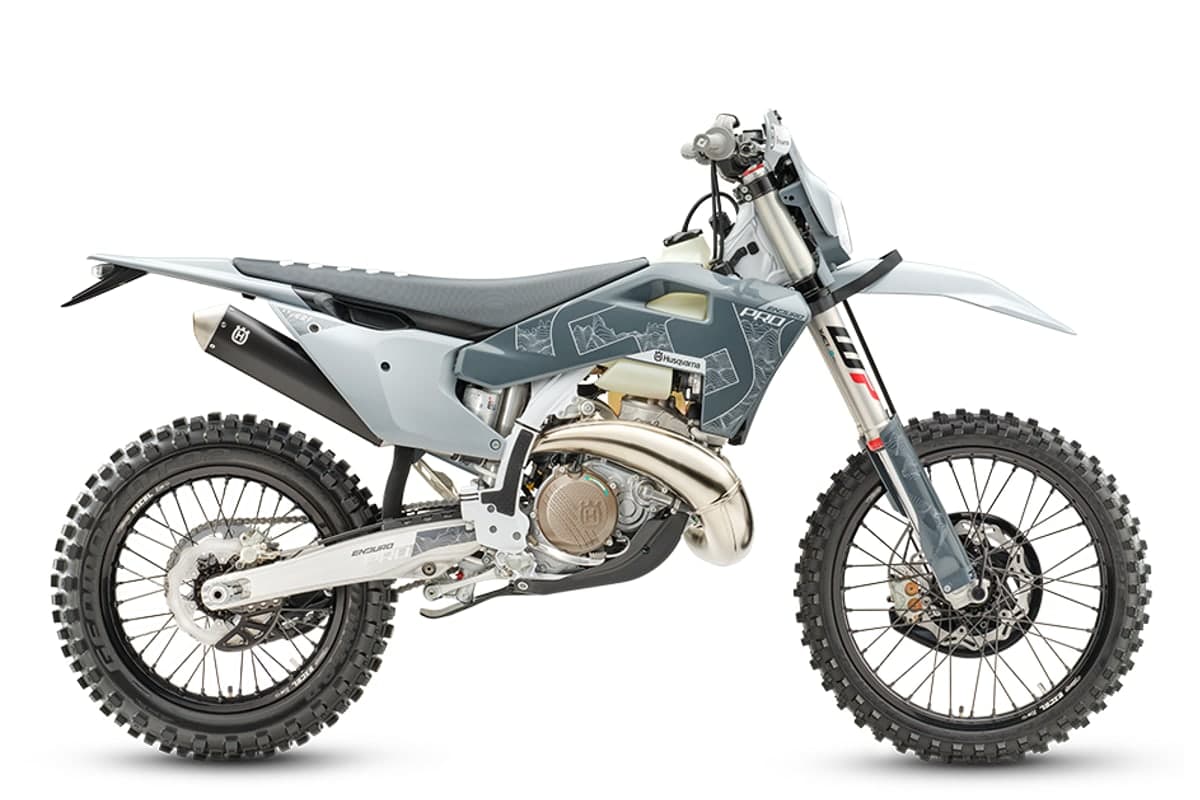 Husqvarna TE 300 Pro two-stroke enduro bike in white and blue, right-side studio profile showing the WP XACT fork and skid plate