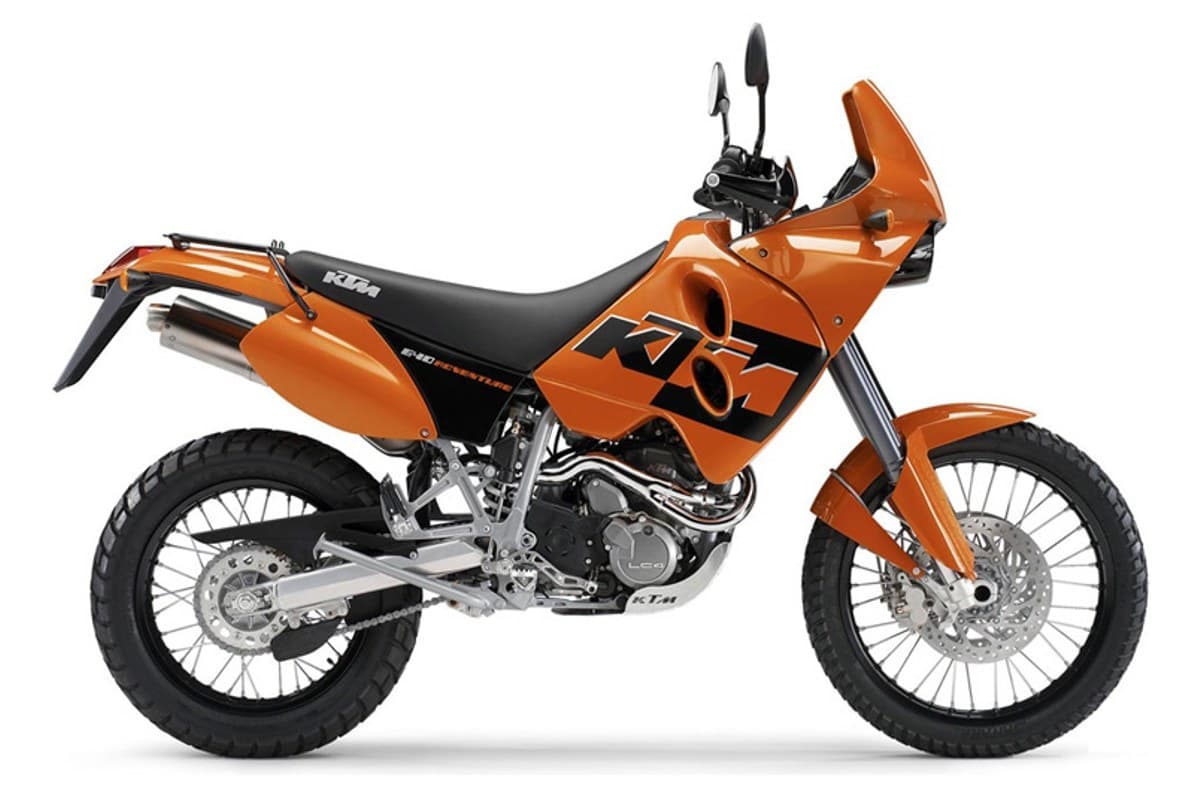 2007 KTM 640 Adventure dual-sport motorcycle in orange and black, right-side studio profile showing the twin round headlights and single exhaust