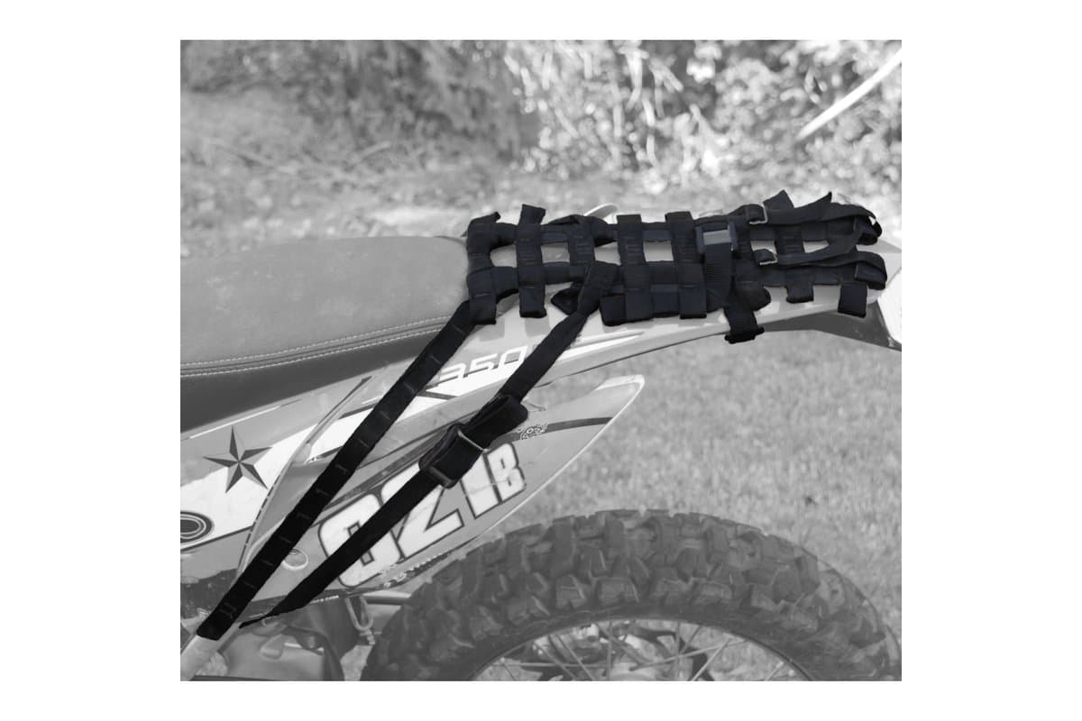 Hardcore Soft Rack webbing strapped over the rear fender of a dirt bike, no bags fitted
