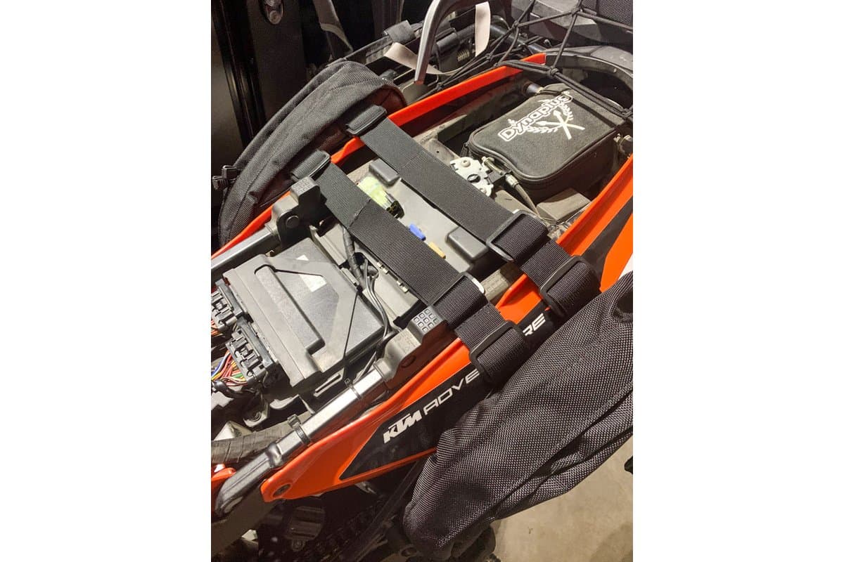 Cradle straps running under the seat of a KTM adventure bike