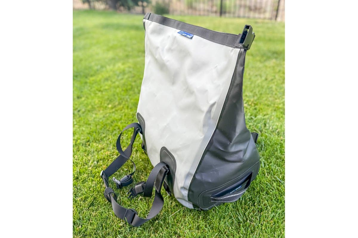 Duffel unrolled and open, standing on grass