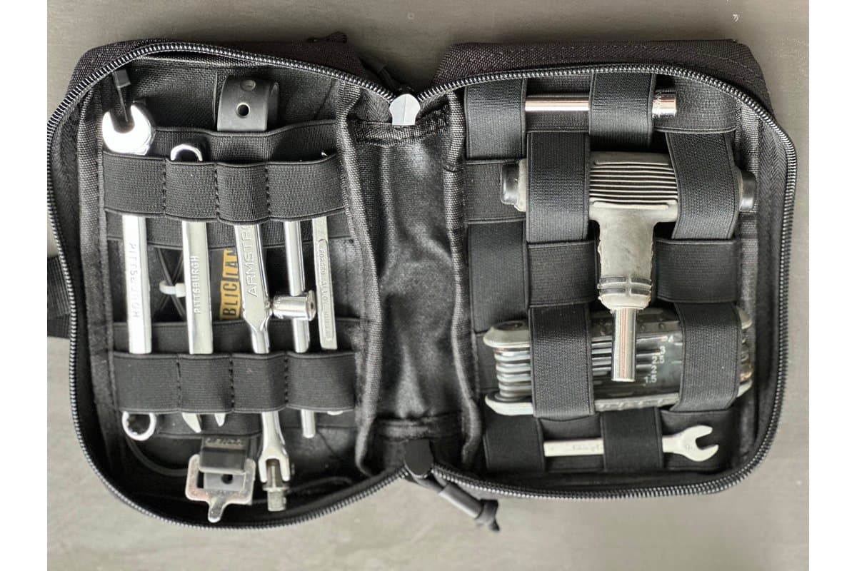 Handlebar Tool Bag opened flat with tools held in elastic webbing