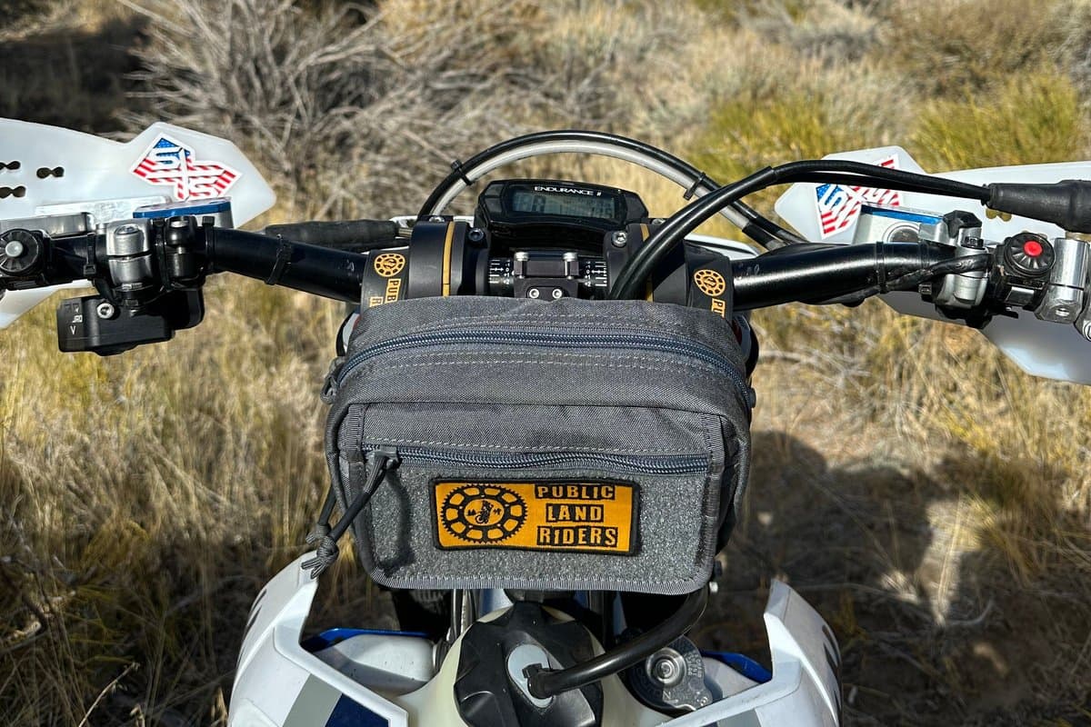 Grey Medium Handlebar Bag 2.0 mounted on a dirt bike handlebar