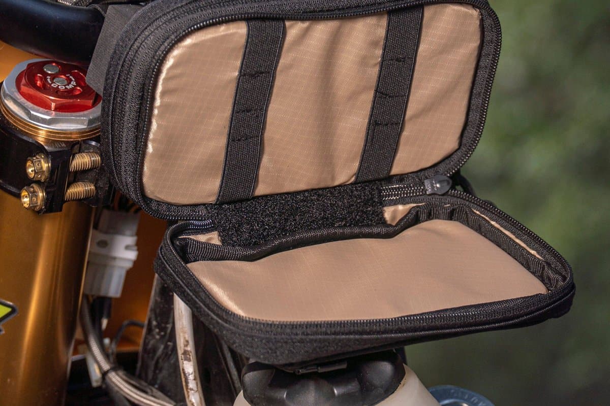 Pad Pack Small Double Decker open on the handlebar showing its tan-lined compartments