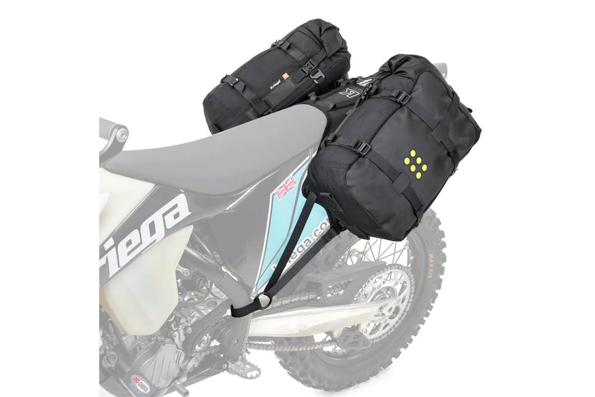 OS-18 Adventure Pack pair mounted on the OS-Base Dirtbike harness, shown over a faded enduro bike