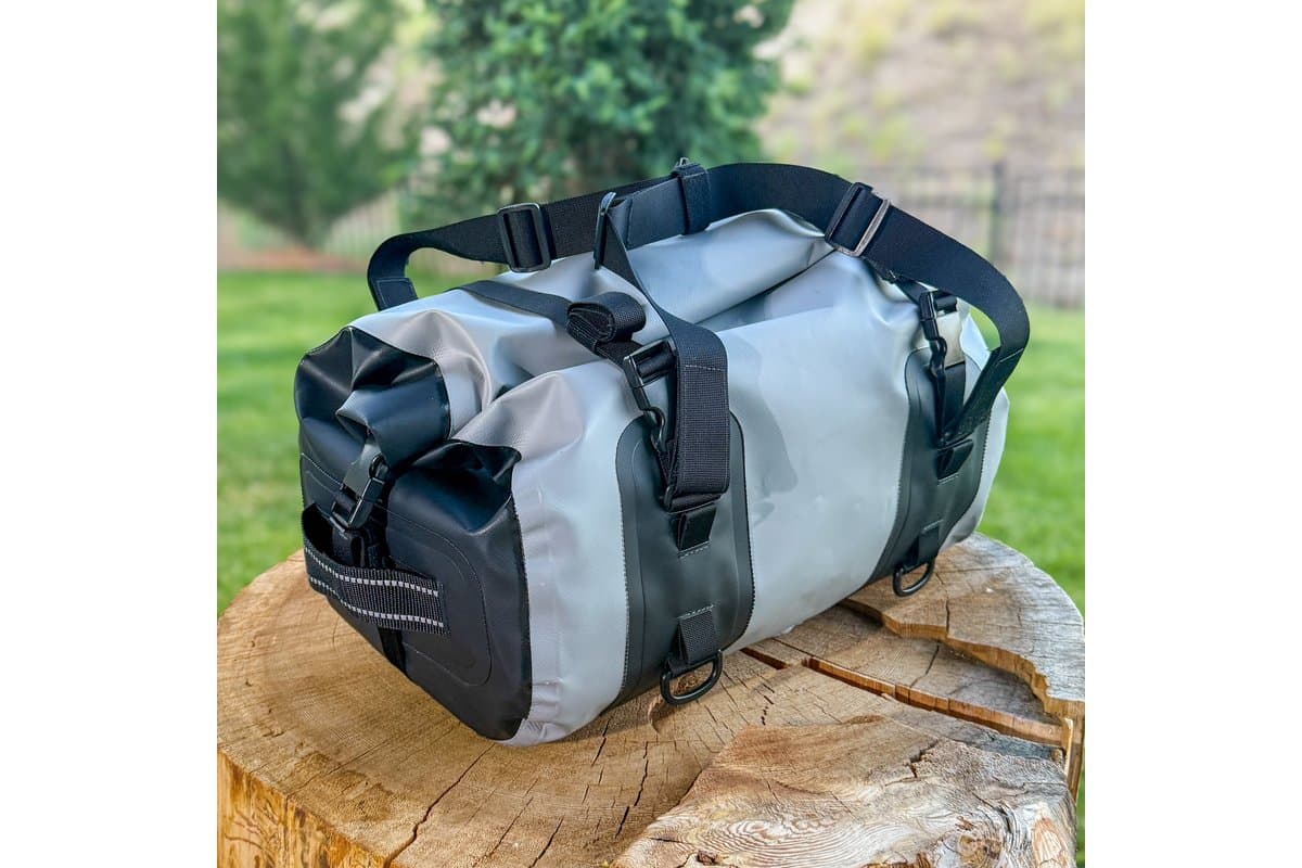 OBR 35L dry duffel in grey and black on a tree stump