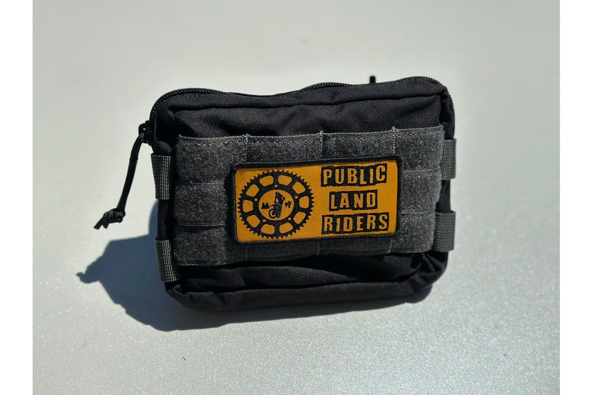 Black Small Handlebar Bag 2.0 with Public Land Riders patch on a light surface