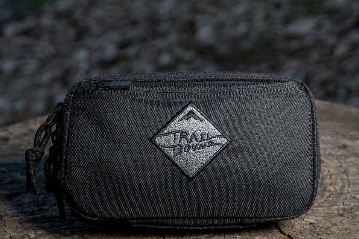 Black Pad Pack Small with grey diamond patch on a tree stump