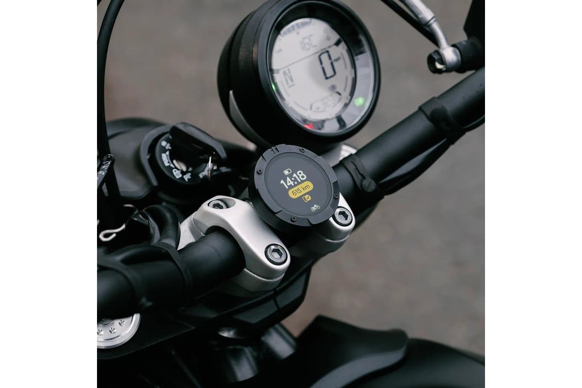 Beeline Moto II mounted on a motorcycle handlebar clamp below the speedometer