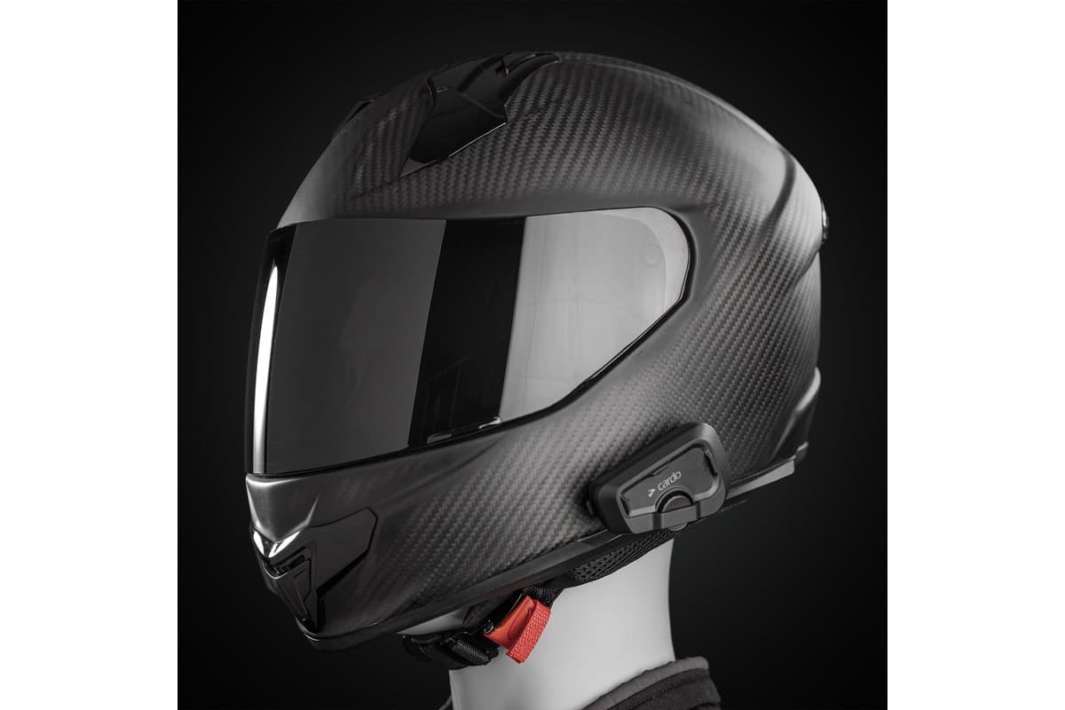 Cardo Freecom 2x mounted on the left side of a carbon full-face helmet on a mannequin