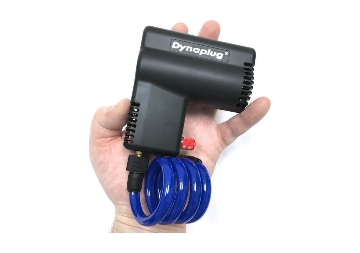 Micro Pro Inflator held in an open hand to show its size