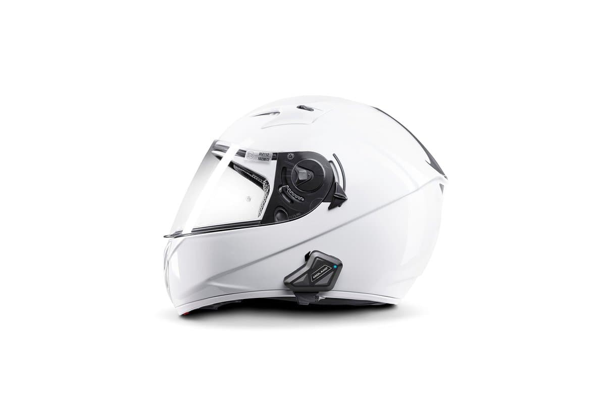 Midland BT Mini mounted on the left side of a white full-face helmet