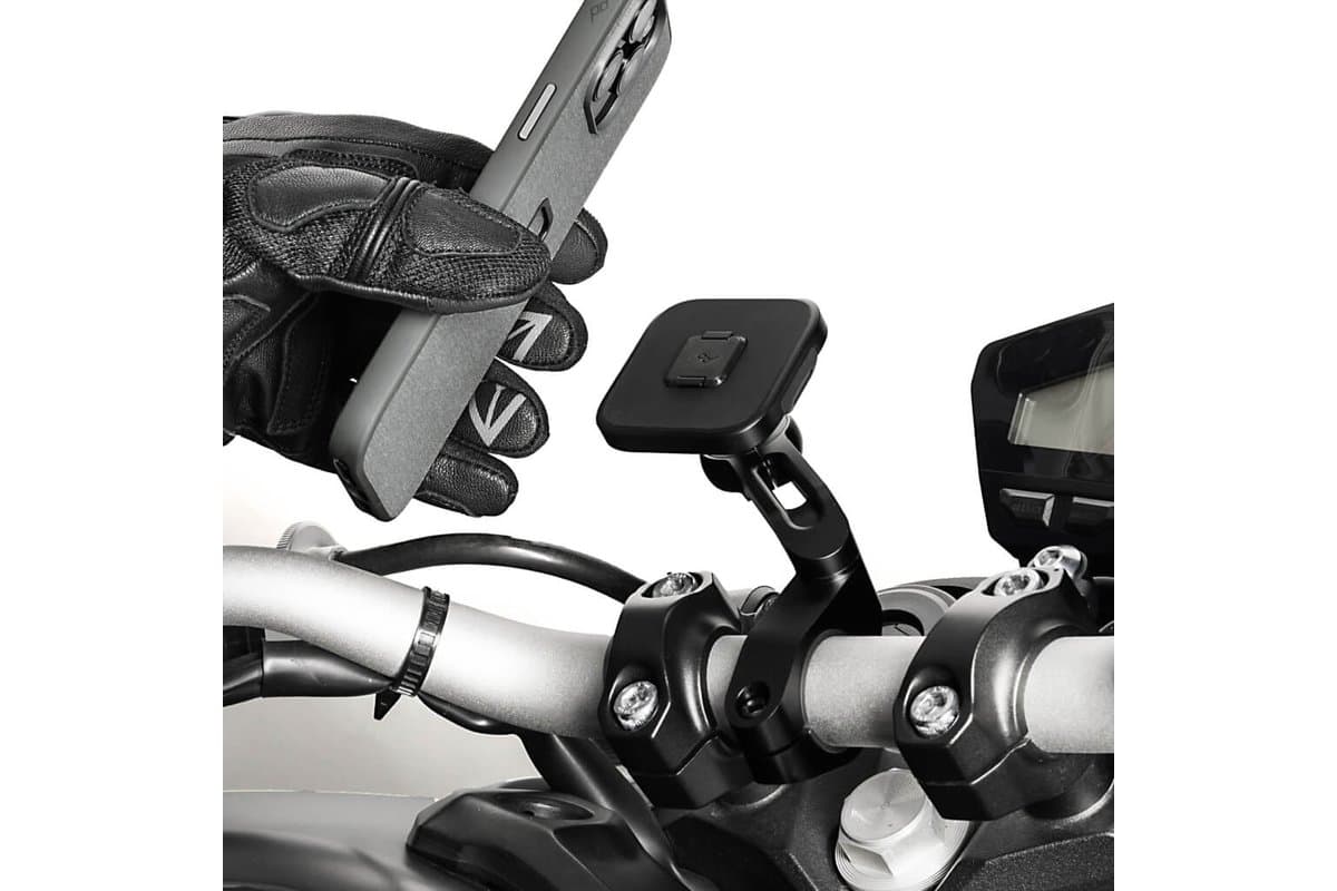 Gloved hand attaching a phone to a Bar Mount V2 fitted to a motorcycle handlebar