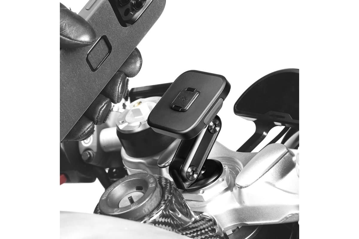 Gloved hand attaching a phone to a Stem Mount fitted in a motorcycle's steering stem
