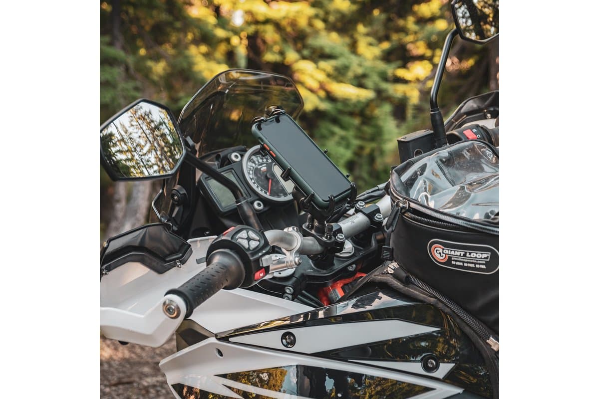 Quick-Grip XL holding a phone on the handlebar of an adventure motorcycle with a tank bag