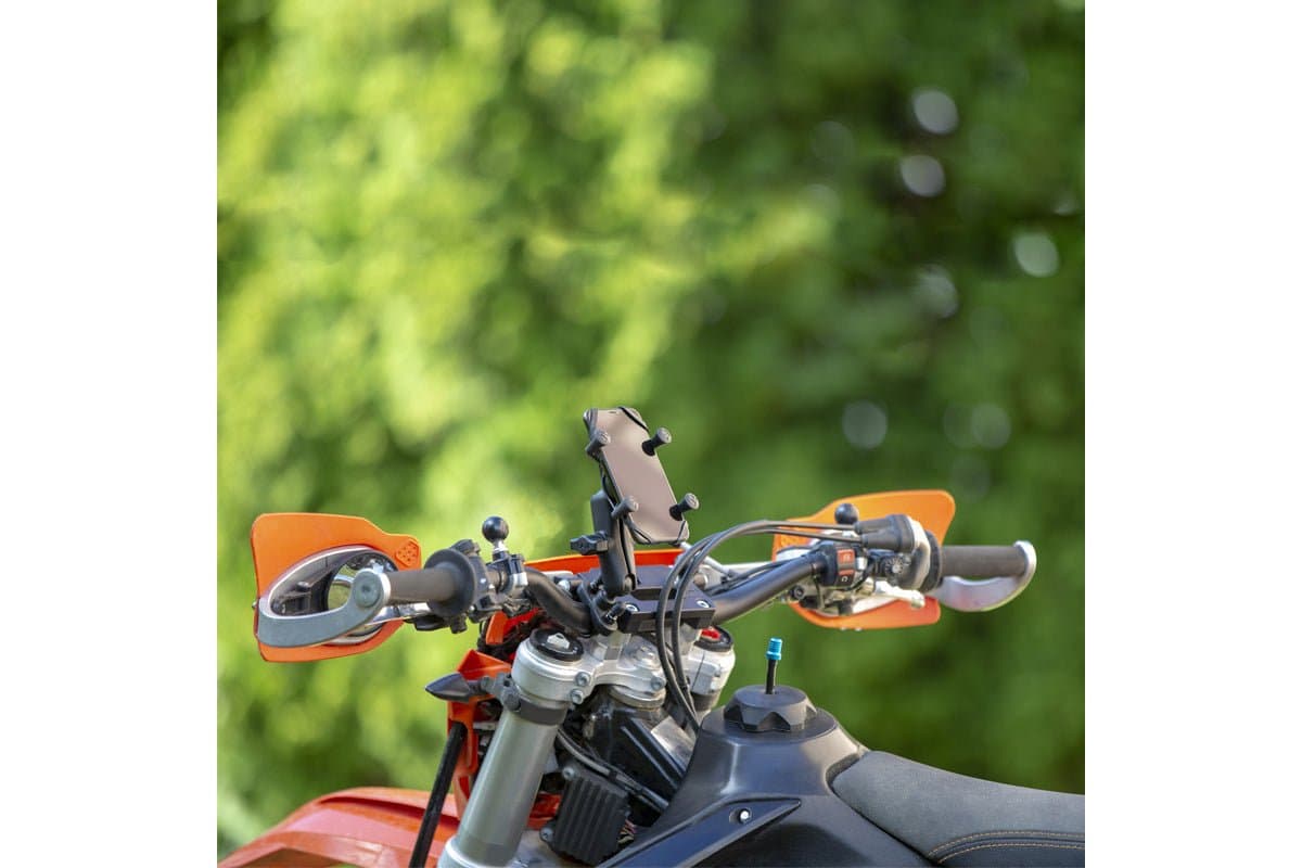 RAM X-Grip mount on the handlebar of an orange dirt bike with handguards