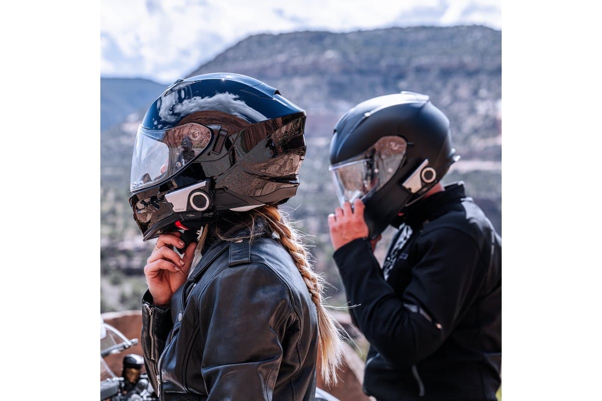 Two riders putting on helmets fitted with Sena headsets, from Sena's 60S EVO listing