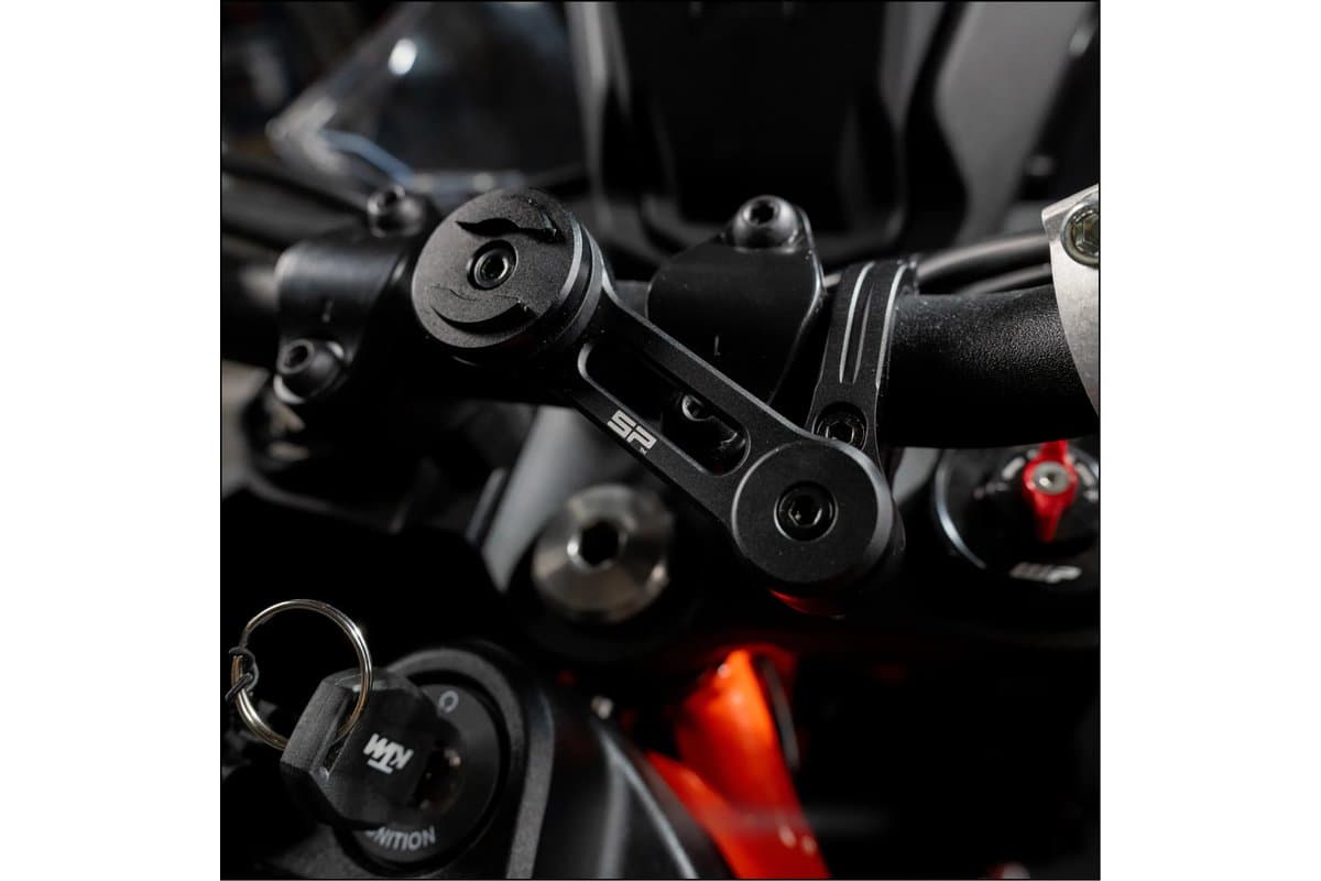 Moto Mount Pro clamped to a motorcycle handlebar beside the ignition