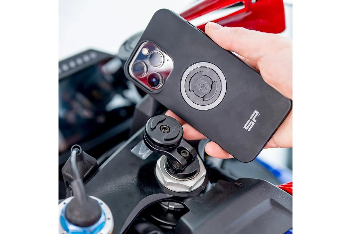 Hand lowering a phone in an SP Connect case onto a Moto Stem Mount