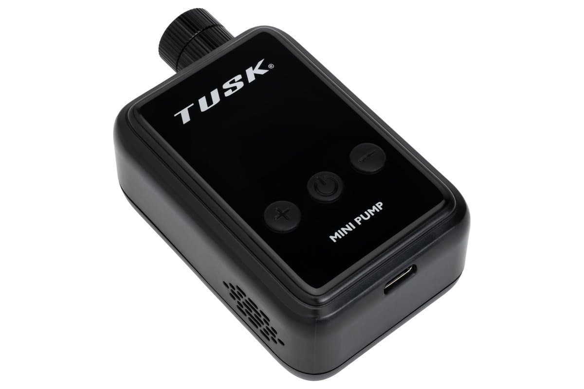 The inflator from the side, showing the air outlet and charging port