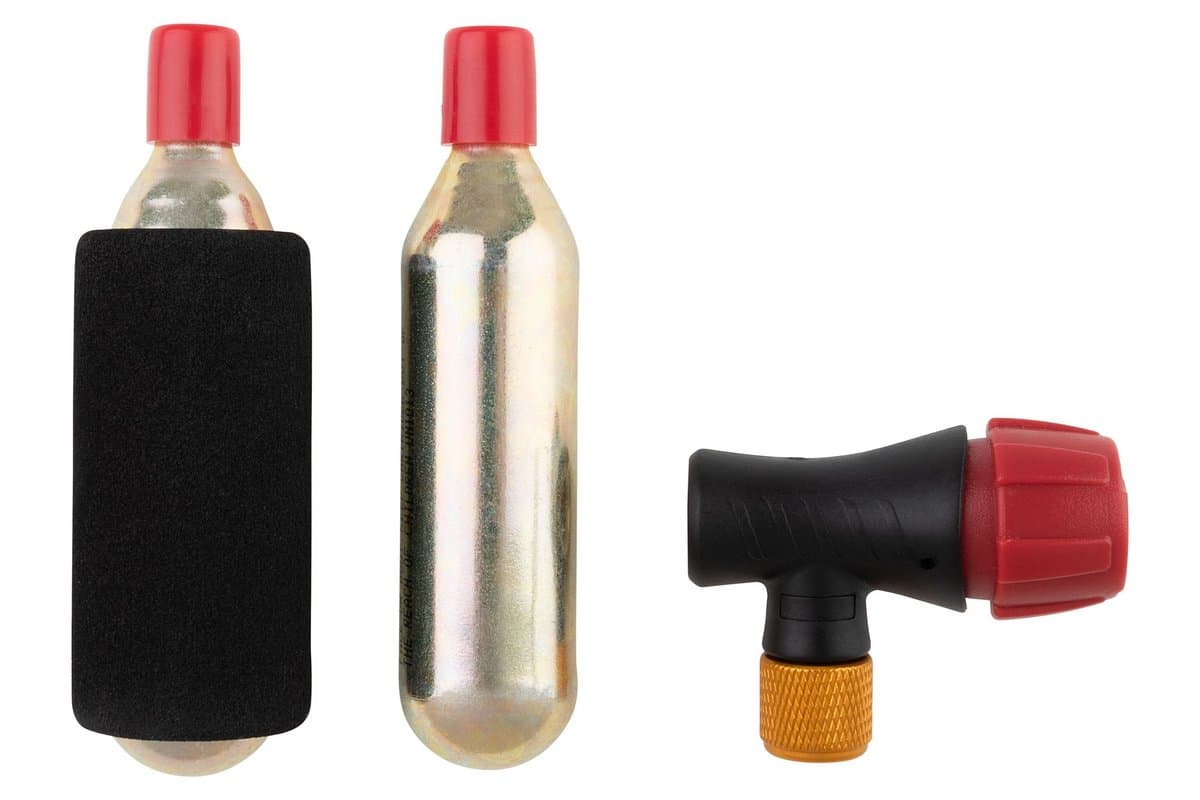 Tusk 16 Gram CO2 Inflator Kit: the inflator head, two cartridges and a foam cartridge insulator