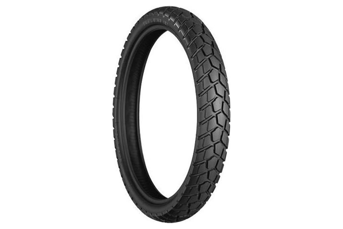Bridgestone Trail Wing TW101 front tire, three-quarter view of the block tread, on white