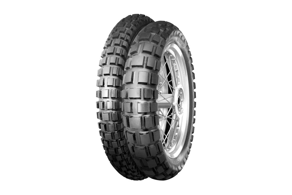 Continental TKC 80 Twinduro: front and rear tire in a three-quarter view, the rear on a polished spoked rim, big square knobs, on white